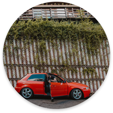 Young driver getting out of red car