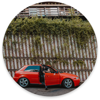 Young driver getting out of red car