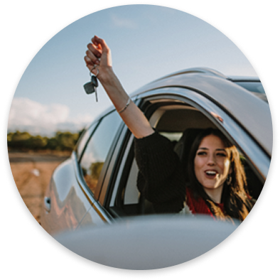 Woman driving a car with renewed insurance